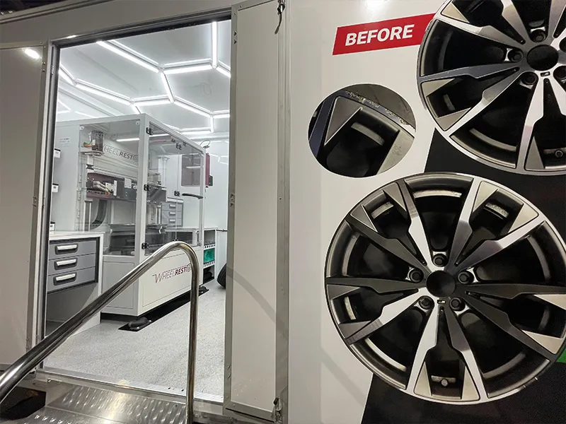 Technician working on a wheel in the refinishing bay